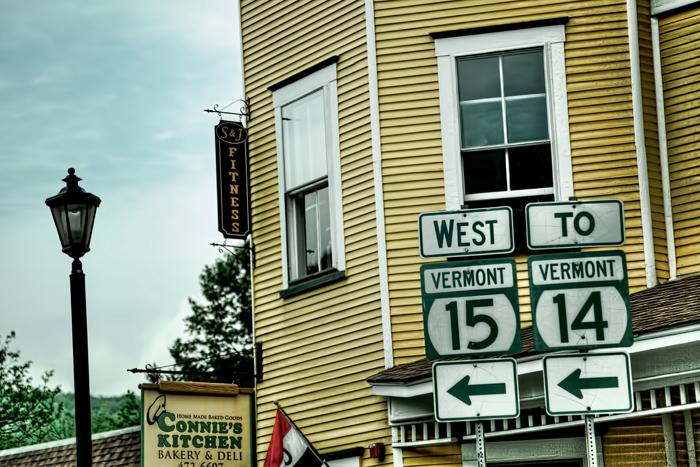Road signs in Hardwick, Vermont near Connie's Kitchen Bakery & Deli.